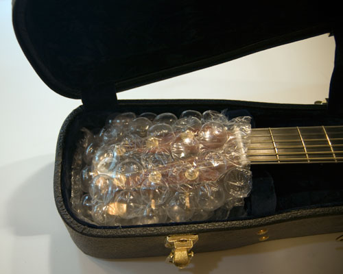 Photo of headstock wrapped in bubble wrap.